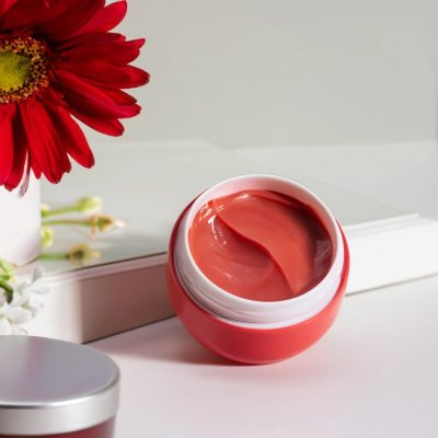 cream-cosmetic-products-face-body-red-cream-white-table-flower
